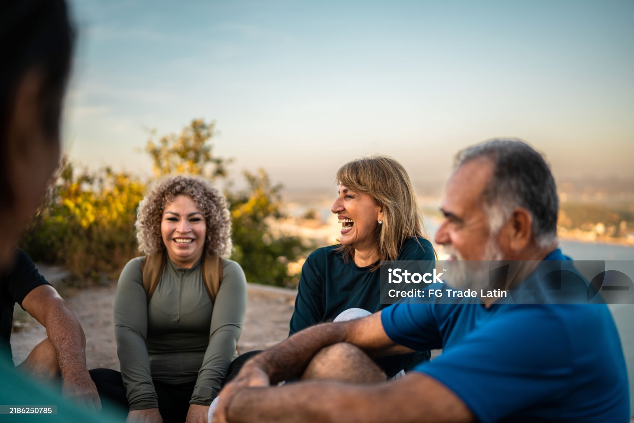 Senior Friends Talking During Hiking Outdoors