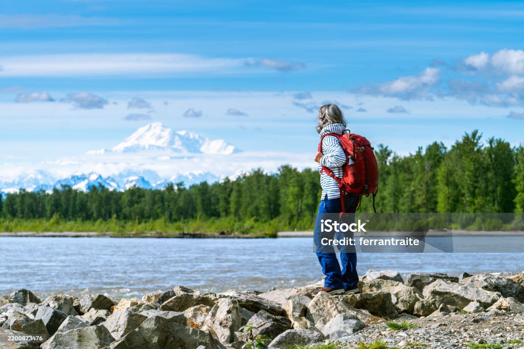 Group Of Hikers Walking In Line On A Footpath In The Mountain, With Copy Space