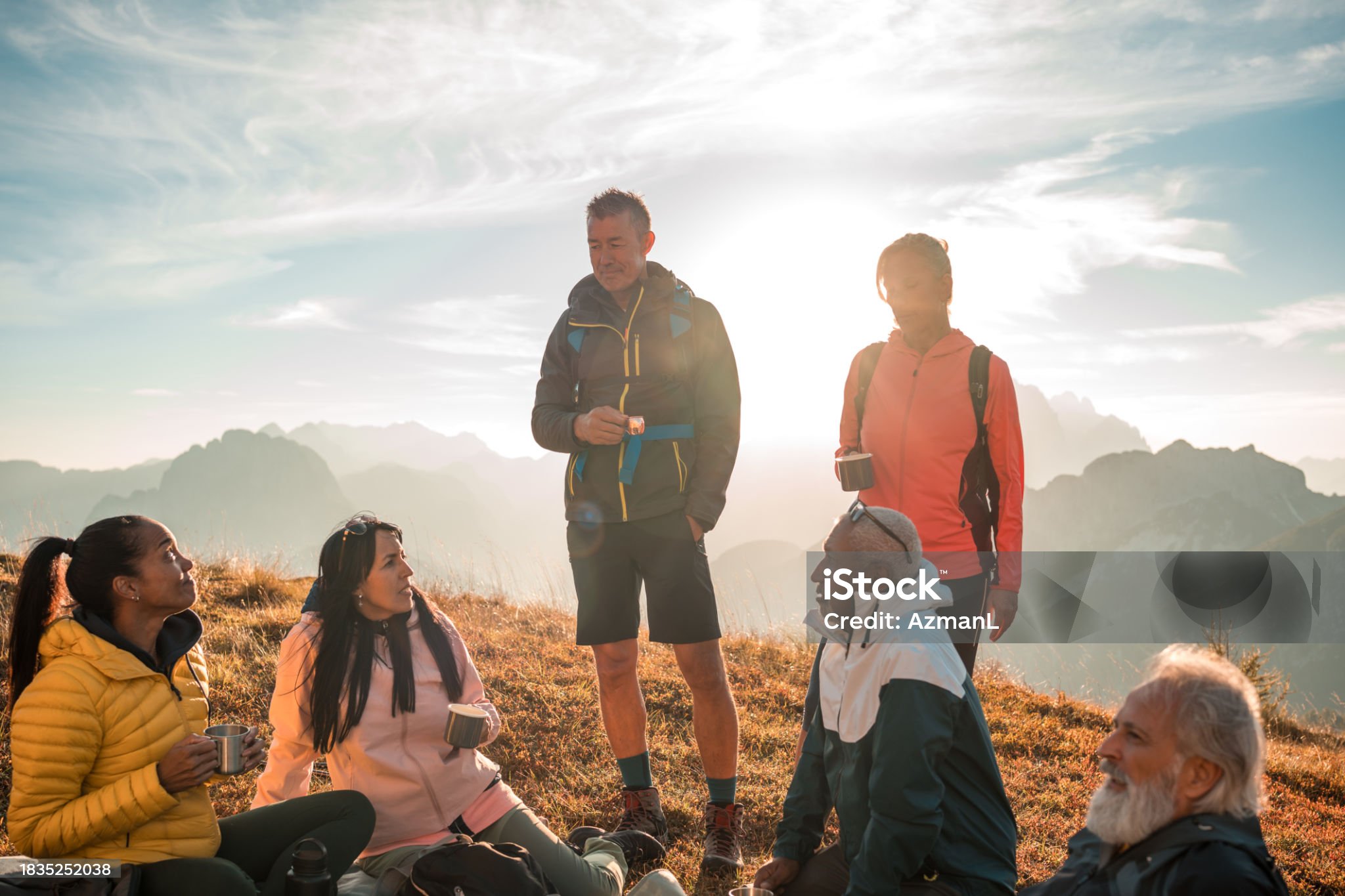 Group Of Hikers Walking In Line On A Footpath In The Mountain, With Copy Space